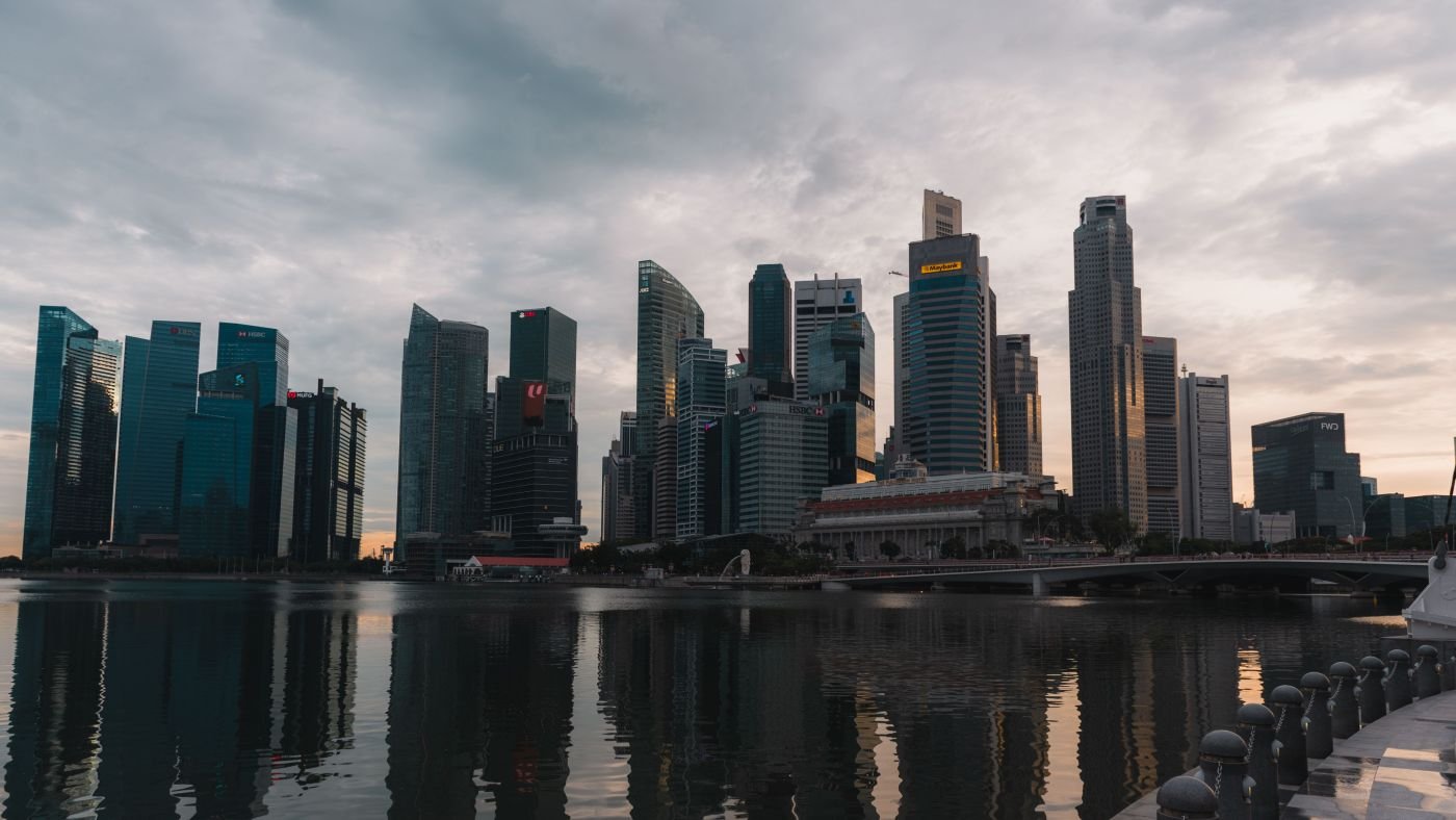 Singapore high-rise skyline at dusk, viewed across the water